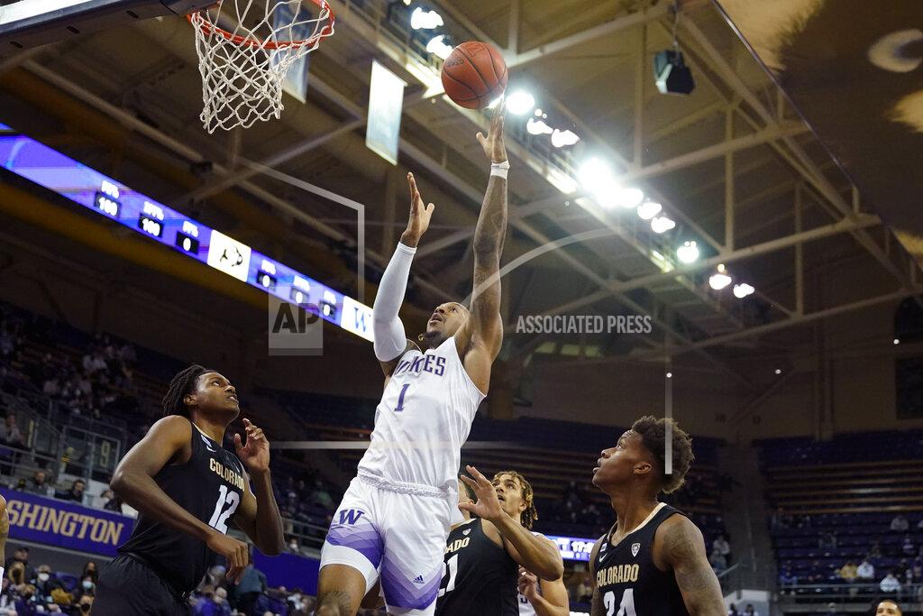 Ted S. Warren Washington forward Nate Roberts (1) shoots as Colorado forward Jabari Walker (12) looks on during the first half of an NCAA college basketball game, Thursday, Jan. 27, 2022, in Seattle. (AP Photo/Ted S. Warren)