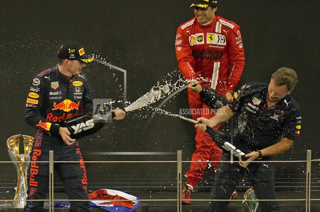Hassan Ammar Red Bull team chief Christian Horner, right, celebrates with his driver Max Verstappen of the Netherlands after winning the Formula One Abu Dhabi Grand Prix in Abu Dhabi, United Arab Emirates, Sunday, Dec. 12, 2021. Max Verstappen ripped a record eighth title away from Lewis Hamilton with a pass on the final lap of the Abu Dhabi GP to close one of the most thrilling Formula One seasons in years as the first Dutch world champion. (AP Photo/Hassan Ammar)
