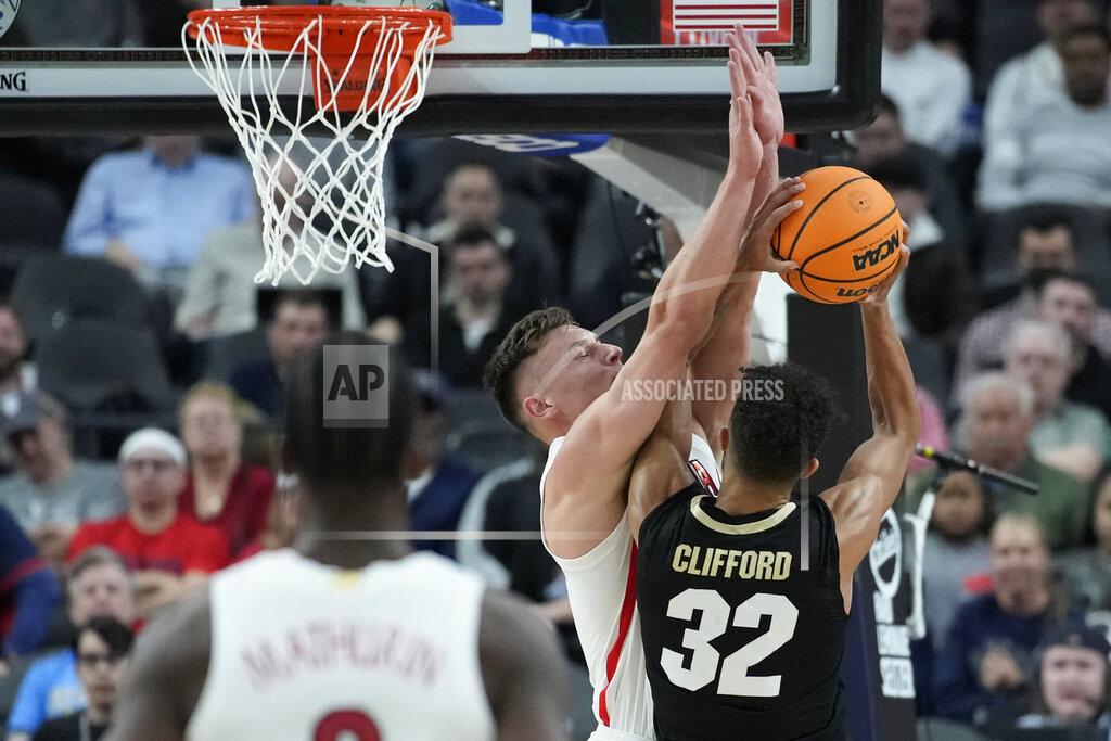 John Locher Arizona's Pelle Larsson (3) blocks a shot by Colorado's Nique Clifford (32) during the first half of an NCAA college basketball game in the semifinal round of the Pac-12 tournament Friday, March 11, 2022, in Las Vegas. (AP Photo/John Locher)