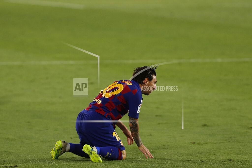 Barcelona's Lionel Messi reacts during the Spanish La Liga soccer match between Sevilla and FC Barcelona at the Ramon Sanchez-Pizjuan stadium in Seville, Spain, Friday, June 19, 2020. (AP Photo/Angel Fernandez)