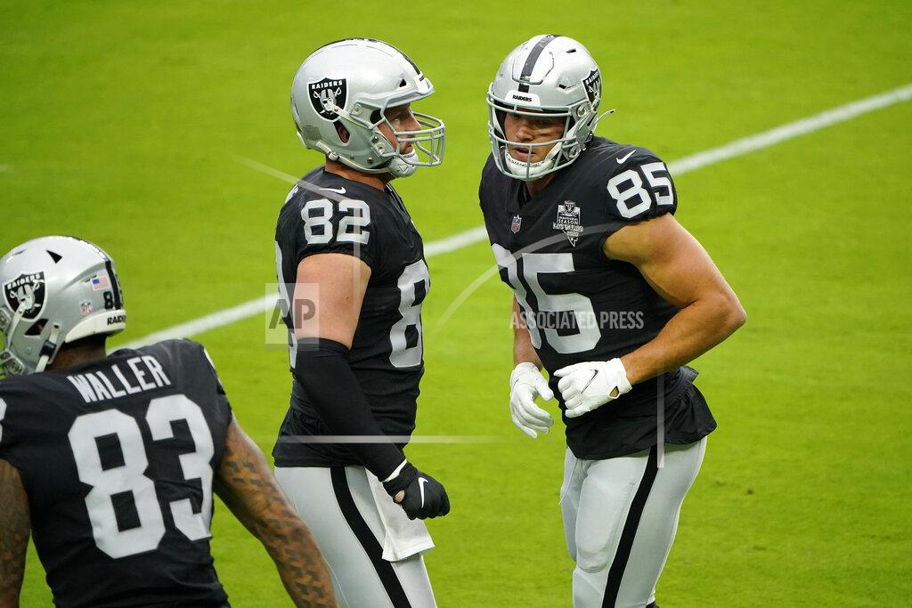 John Locher Las Vegas Raiders tight end Jason Witten (82) and end Derek Carrier (85) run a drill during an NFL football training camp practice Friday, Aug. 28, 2020, in Las Vegas. (AP Photo/John Locher)