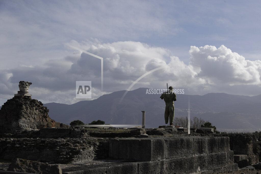 Gregorio Borgia A partial view of the archeological site of Pompeii during the inauguration of the museum Antiquarium, in Pompeii, southern Italy, Monday, Jan. 25, 2021. Decades after suffering bombing and earthquake damage, Pompeii's museum is back in business, showing off exquisite finds from excavations of the ancient Roman city. Officials of the archaeological park of the ruins of the city destroyed in 79 A.D. by the eruption of Mount Vesuvius inaugurated the museum on Monday. (AP Photo/Gregorio Borgia)
