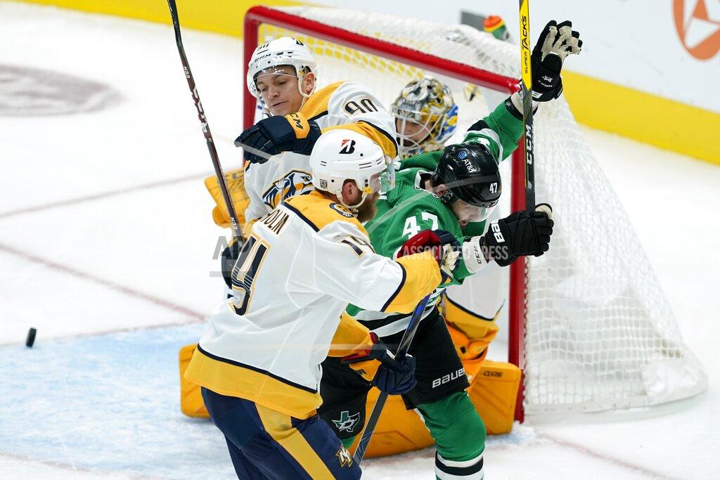 Tony Gutierrez Dallas Stars right wing Alexander Radulov (47) celebrates his goal, between between Nashville Predators defensemen Mattias Ekholm (14) and Mark Borowiecki (90) during the second period of an NHL hockey game in Dallas, Friday, Jan. 22, 2021. (AP Photo/Tony Gutierrez)