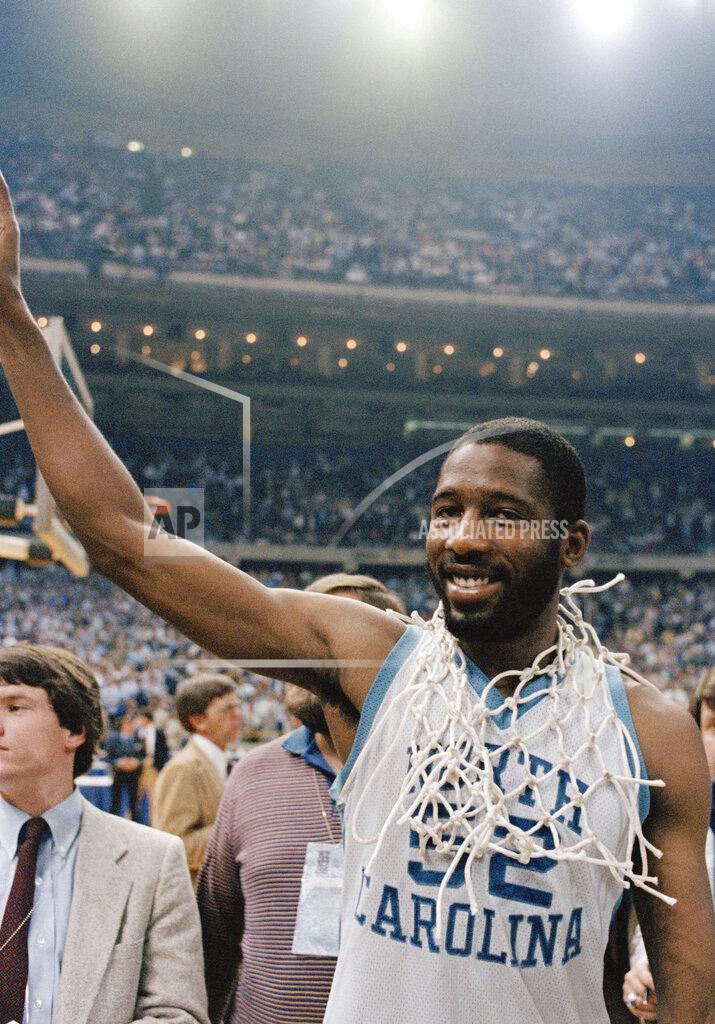 Anonymous FILE - In this March 29, 1982, file photo, North Carolina's James Worthy wears the net after it was cut down following North Carolina defeating Georgetown 68-62 in the NCAA college basketball Final Four championship in New Orleans. Worthy won the duel of dunks with Georgetown's Pat Ewing, scoring a career-high 28 points and winning the Most Outstanding Player award. (AP Photo/File)