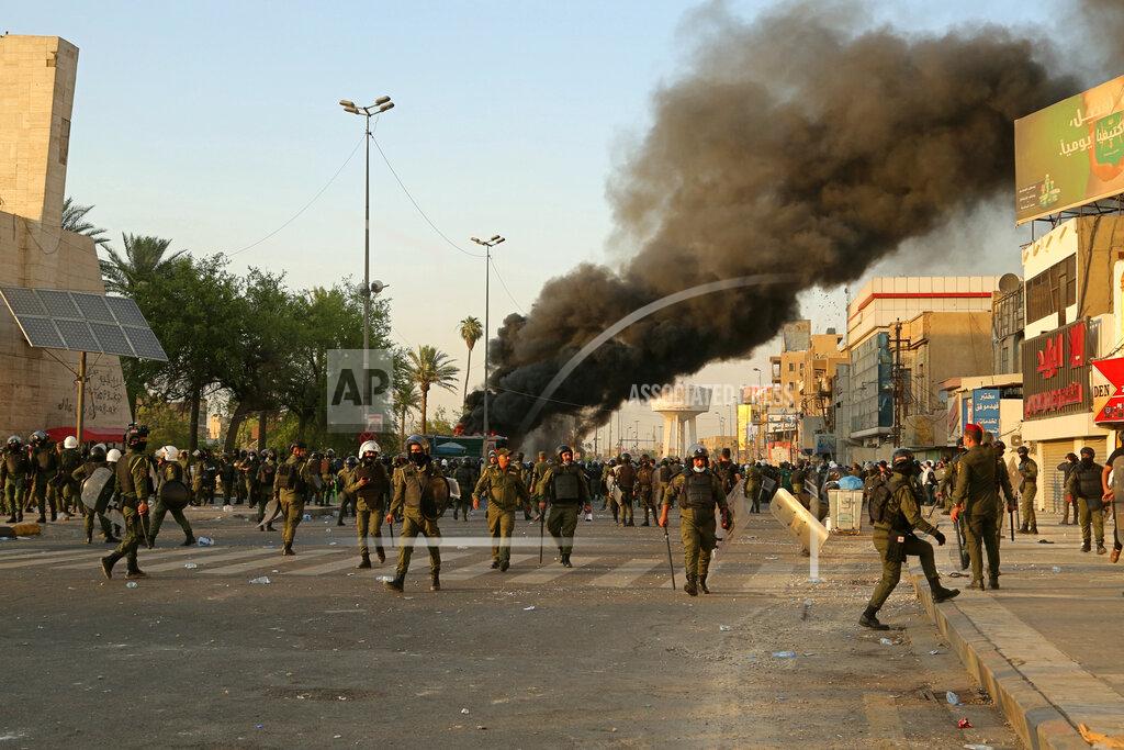 Hadi Mizban Smoke rises during clashes between security forces and anti-government protesters in Tahrir Square in Baghdad, Iraq, Tuesday, May 25, 2021. Hundreds of Iraqis took to the streets in Baghdad on Tuesday to protest what they say is impunity by those behind a rising number of targeted killings of prominent activists and journalists. (AP Photo/Hadi Mizban)