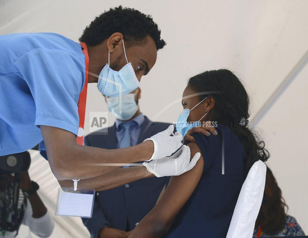 Samuel Habtab Dr Tenaye Desalegn from the Eka Kobe General Hospital, receives a dose of the AstraZeneca COVID-19 vaccine, in Addias Ababa, Ethiopia, Saturday, March 13, 2021, after the launch of the vaccine in Ethiopia. (AP Photo/Samuel Habitat)