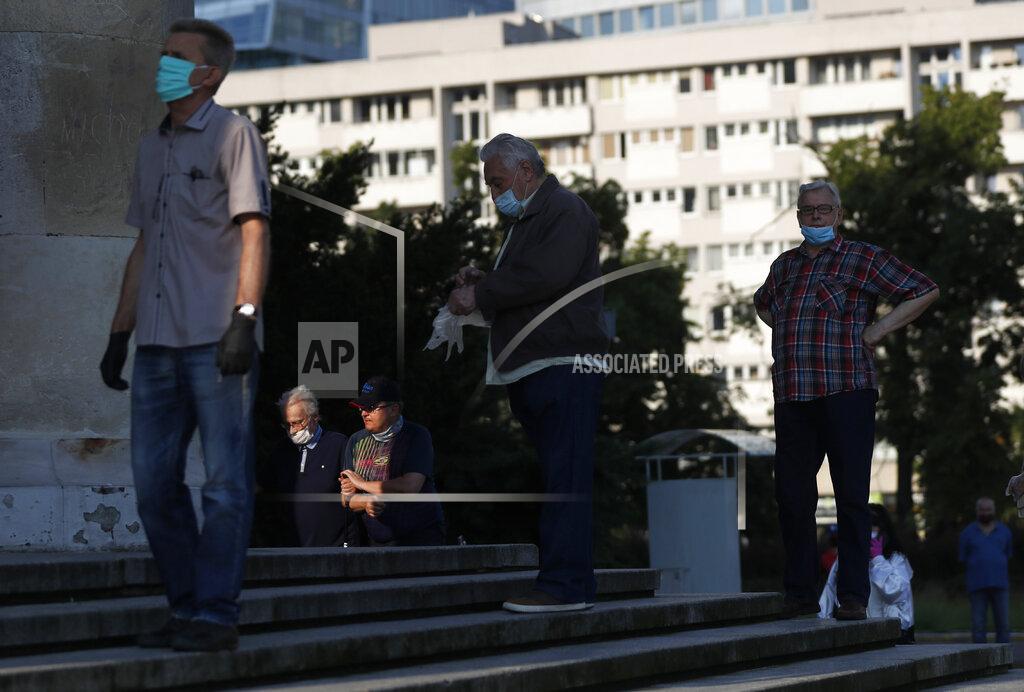 Petr David Josek People keep social distancing while waiting in line to cast their vote in presidential election in Warsaw, Poland, Sunday, June 28, 2020. The election will test the popularity of incumbent President Andrzej Duda who is seeking a second term and of the conservative ruling party that backs him. (AP Photo/Petr David Josek)