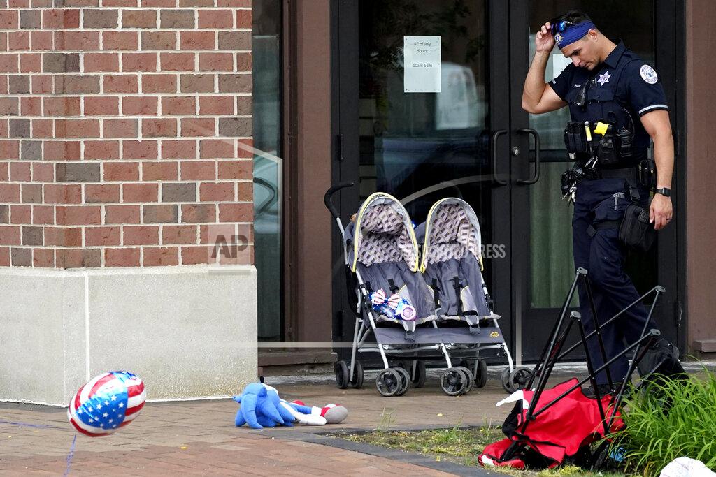 Nam Y. Huh A police officer reacts as he walks in downtown Highland Park, a suburb of Chicago, Monday, July 4, 2022, where a mass shooting took place at a Highland Park Fourth of July parade. (AP Photo/Nam Y. Huh)