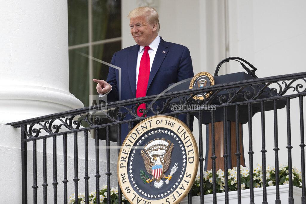 Alex Brandon President Donald Trump points during a "Rolling to Remember Ceremony," to honor the nation's veterans and POW/MIA, from the Blue Room Balcony of the White House, Friday, May 22, 2020, in Washington. (AP Photo/Alex Brandon)