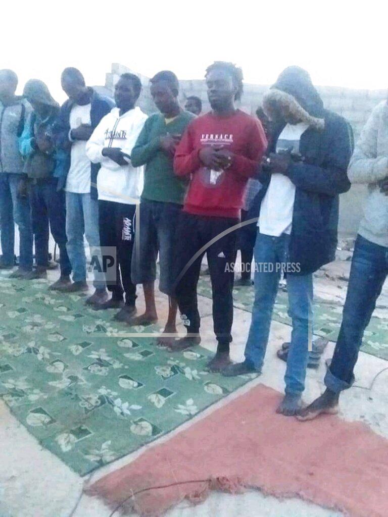 Uncredited In this photo provided by the family of Mubarak Jaber, Jaber and other migrants are seen praying before they prepare to board a smuggler’s boat in the town of al-Khums, Libya, April 20, 2021. Mubarak Jaber is believed to be among more than 100 migrants and refugees to have died when their rubber boat went under in the Mediterranean Sea north of Libya on April 21, 2021. When they called repeatedly for help in late April, a rescue never came. It was the deadliest wreck so far this year in the Mediterranean Sea and has renewed accusations that European countries are failing to help migrant boats in trouble. (Family handout via AP)