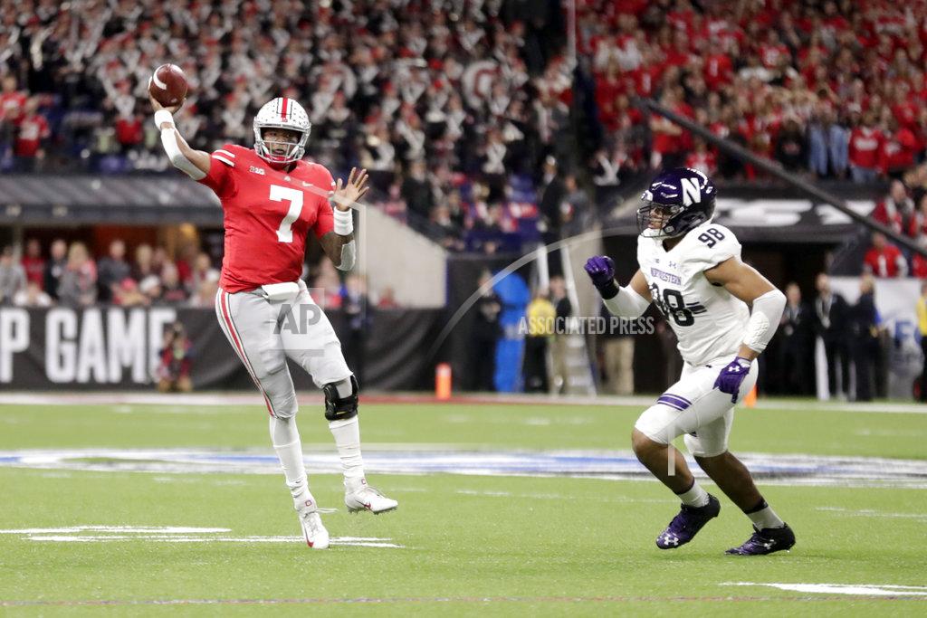 Michael Conroy Ohio State quarterback Dwayne Haskins (7) throws a touchdown pass as Northwestern's Earnest Brown IV (98) defends during the first half of the Big Ten championship NCAA college football game, Saturday, Dec. 1, 2018, in Indianapolis. (AP Photo/Michael Conroy)