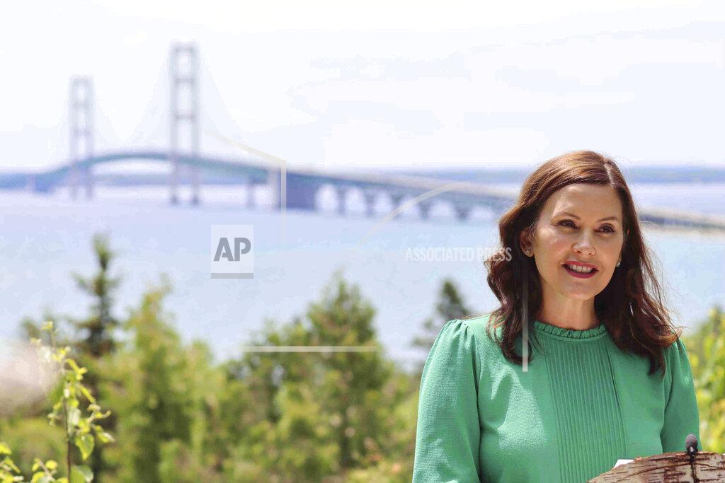 Uncredited FILE - In this June 10, 2021 file photo provided by the Michigan Office of the Governor, Gov. Gretchen Whitmer speaks at Straits State Park in St. Ignace, Mich., with the Mackinac Bridge behind her. Michigan will lift all indoor capacity restrictions and mask requirements next week, 10 days sooner than planned amid vaccinations and plummeting COVID-19 infections, Whitmer announced Thursday, June 17. (Michigan Office of the Governor via AP, File)