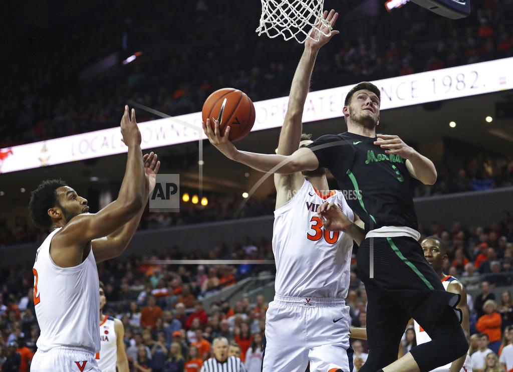 Zack Wajsgras Marshall's Jannson Williams (3) tries to sneak a shot past Virginia's forward Jay Huff (30) in the first half of an NCAA college basketball game on Monday, Dec. 31, 2018, in Charlottesville, Va. (AP Photo/Zack Wajsgras)