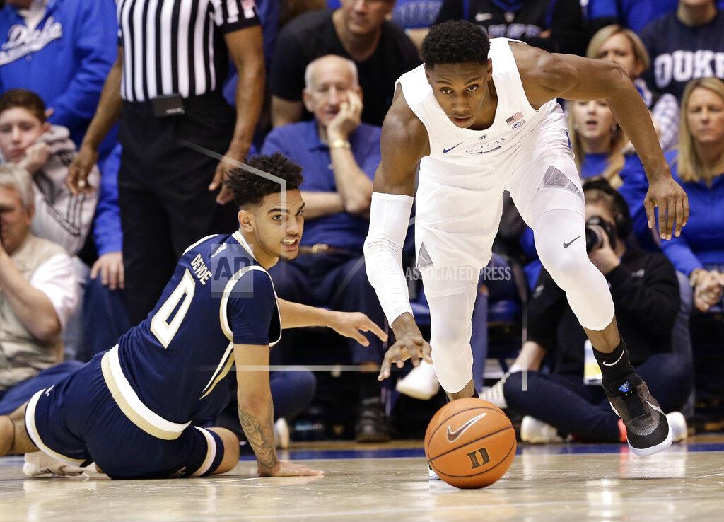 Gerry Broome Duke's RJ Barrett, right, chases the ball as Georgia Tech's Michael Devoe (0) looks on during the second half of an NCAA college basketball game in Durham, N.C., Saturday, Jan. 26, 2019. Duke won 66-53. (AP Photo/Gerry Broome)