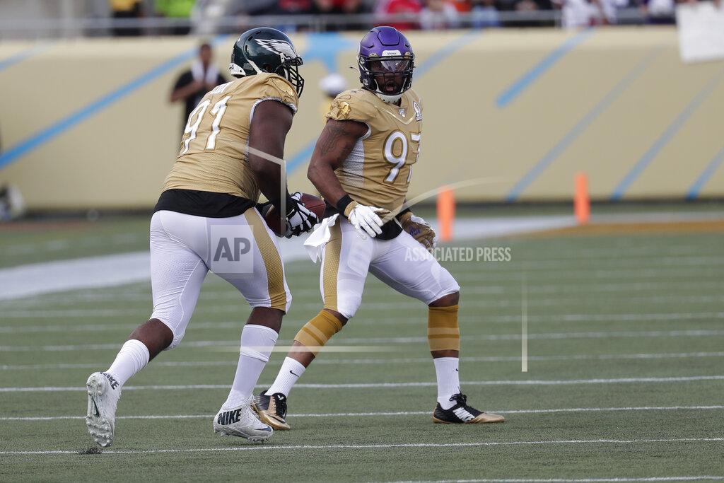 John Raoux NFC defensive end Fletcher Cox, of the Philadelphia Eagles, runs for a touchdown, after an interception by strong safety Harrison Smith, of the Minnesota Vikings, (22), during the second half of the NFL Pro Bowl football game against the AFC, Sunday, Jan. 26, 2020, in Orlando, Fla. To the right is defensive end Everson Griffen, of the Minnesota Vikings (97). (AP Photo/John Raoux)