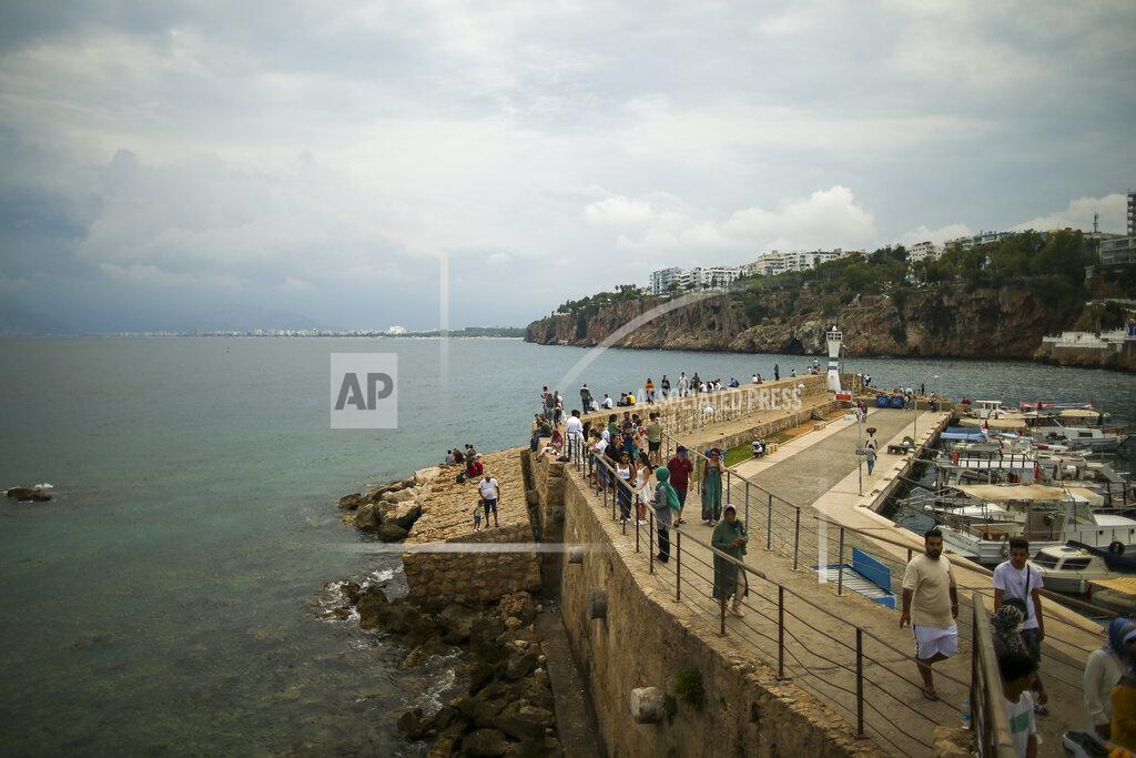 Emrah Gurel Tourist visit the old harbour, in Antalya, southern Turkey, Monday, June 21, 2021. Hotels in Turkey's Antalya region, a destination beloved by holidaymakers, are preparing to finally resume operations as they expect the return of international tourists after months of setbacks caused by the pandemic that halted travel. (AP Photo/Emrah Gurel)