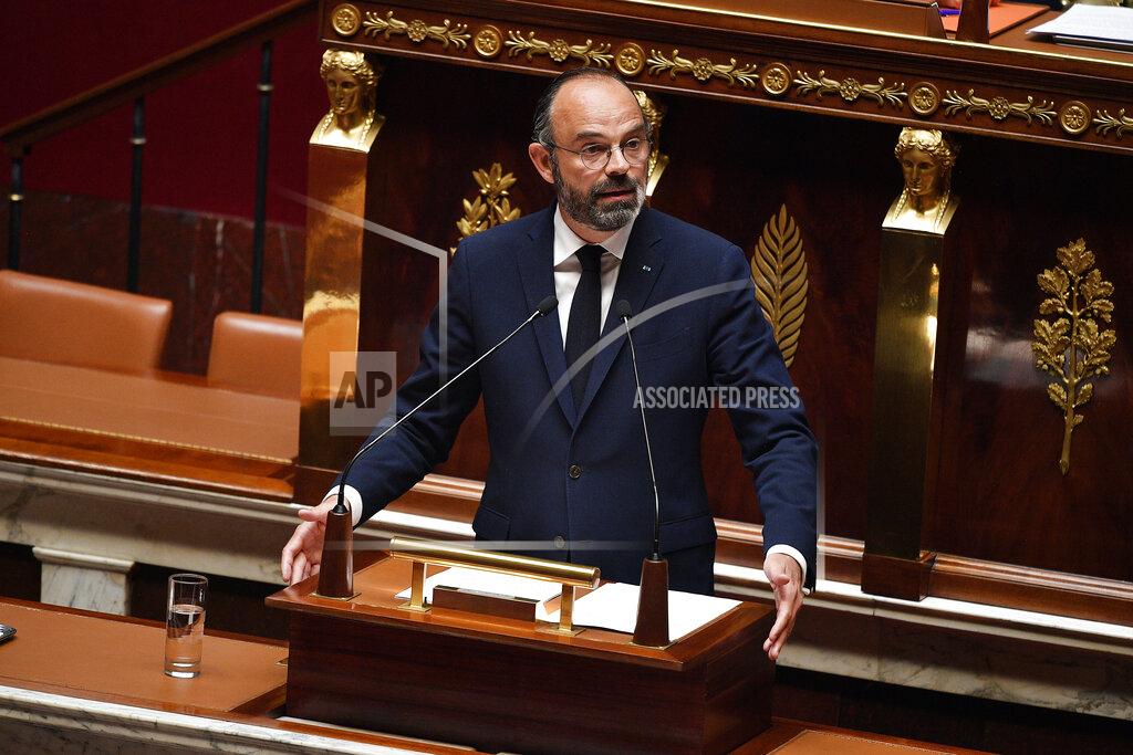 French Prime Minister Edouard Philippe presents his plan to exit from the lockdown at the National Assembly in Paris, Tuesday, April 28, 2020. French Prime Minister Edouard Philippe has outlined a stringent plan to fight coronavirus in France by automatically testing everyone who's come in contact with someone infected with COVID-19. (David Niviere, Pool via AP)