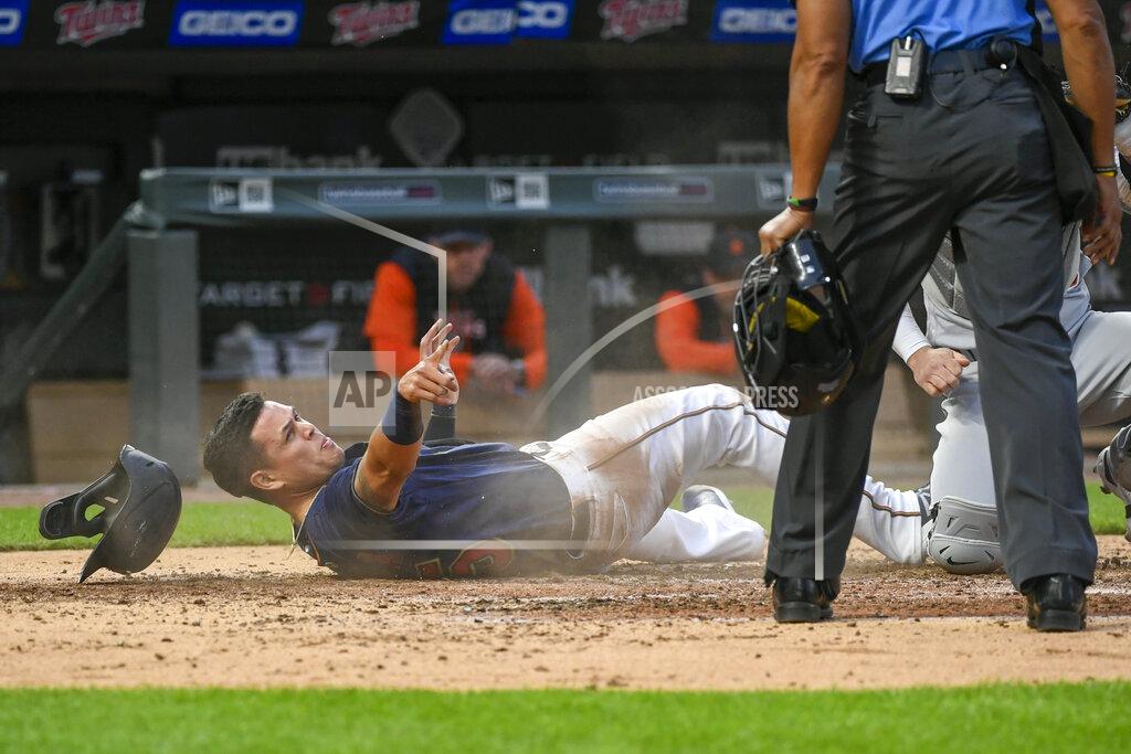 Craig Lassig Minnesota Twins' Gio Urshela, left, looks at home plate umpire CB Bucknor, who prepares to call Urshela out after a tag by Detroit Tigers catcher Tucker Barnhart during the fourth inning of a baseball game Tuesday, May 24, 2022, in Minneapolis. (AP Photo/Craig Lassig)
