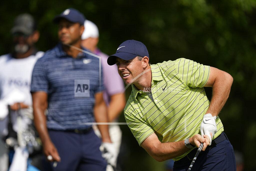 Eric Gay Rory McIlroy, of North Ireland, watches his tee shot as Tiger Woods looks on, on the 17th hole during the first round of the PGA Championship golf tournament, Thursday, May 19, 2022, in Tulsa, Okla. (AP Photo/Eric Gay)