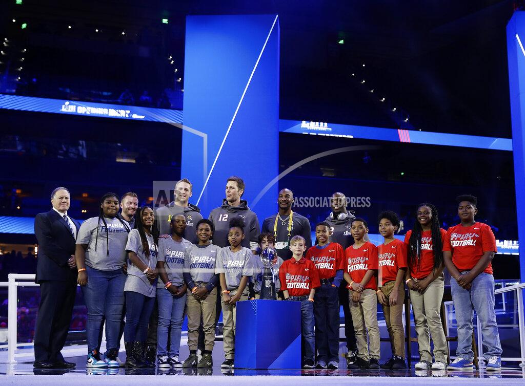 Matt Rourke Members of the New England Patriots and Los Angeles Rams pose for a picture during Opening Night for the NFL Super Bowl 53 football game Monday, Jan. 28, 2019, in Atlanta. (AP Photo/Matt Rourke)