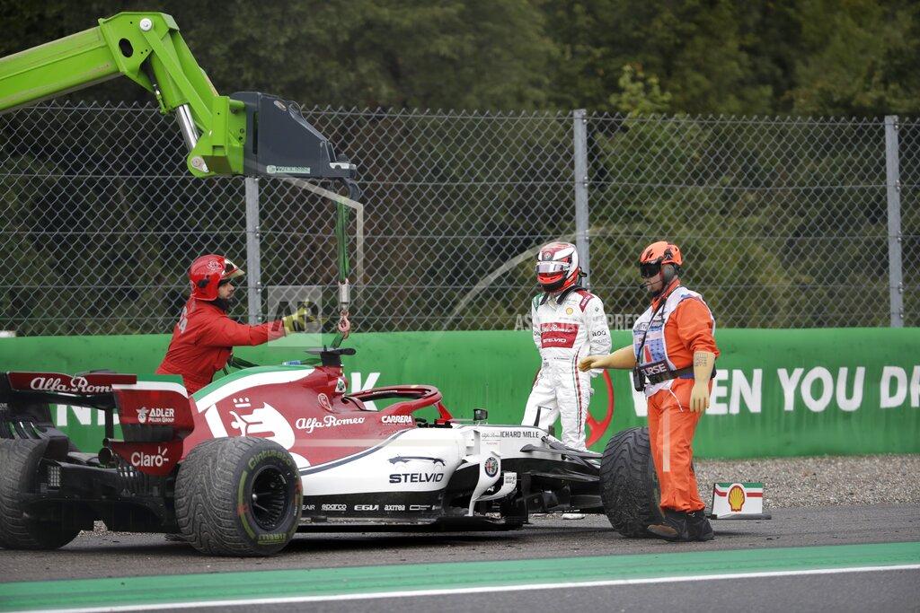 Luca Bruno A crane takes the car of Alfa Romeo driver Kimi Raikkonen of Finland after went off the track during the first free practice at the Monza racetrack, in Monza, Italy, Friday, Sept. 6, 2019. The Formula one race will be held on Sunday. (AP Photo/Luca Bruno)