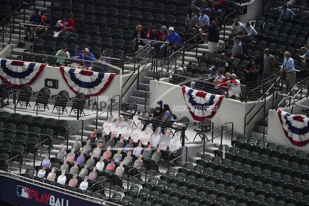 Sue Ogrocki Fans watch near a section of cardboard cutouts during the second inning in Game 1 of a baseball National League Championship Series between the Los Angeles Dodgers and the Atlanta Braves Monday, Oct. 12, 2020, in Arlington, Texas. (AP Photo/Sue Ogrocki)