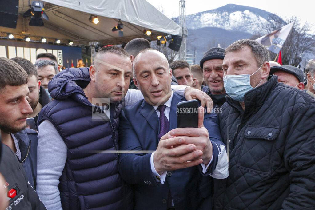 Visar Kryeziu Ramush Haradinaj, centre, candidate for prime minister of the Alliance for the Future of Kosova (AAK) takes a selfie with a supporter during an electoral rally in the town of Peja, Kosovo, photo taken on Wednesday, Feb. 10, 2021. Kosovo holds an early general election on upcoming Sunday Feb. 14, amid the coronavirus pandemic, economic downturn and stalled negotiations with wartime foe Serbia. (AP Photo/Visar Kryeziu)