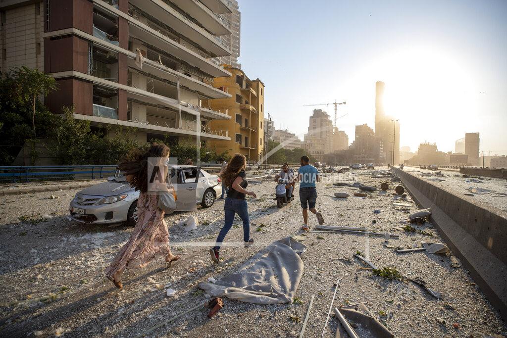 Hassan Ammar Aftermath of a massive explosion is seen in in Beirut, Lebanon, Tuesday, Aug. 4, 2020. Massive explosions rocked downtown Beirut on Tuesday, flattening much of the port, damaging buildings and blowing out windows and doors as a giant mushroom cloud rose above the capital. Witnesses saw many people injured by flying glass and debris. (AP Photo/Hassan Ammar)