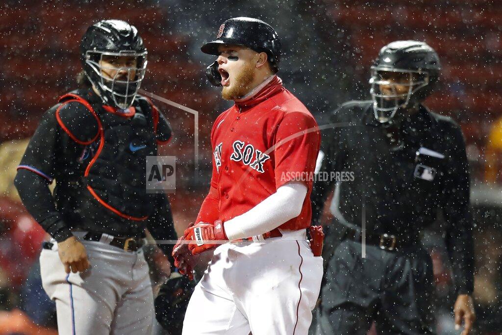 Michael Dwyer Boston Red Sox's Alex Verdugo, center, reacts to his three-run home run in front of Miami Marlins' Jorge Alfaro, left, during the fifth inning of a baseball game, Friday, May 28, 2021, in Boston. (AP Photo/Michael Dwyer)