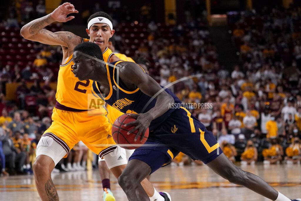 Matt York California forward Kuany Kuany drives as Arizona State forward Jalen Graham (2) defends during the first half of an NCAA college basketball game, Thursday, March 3, 2022, in Tempe, Ariz. (AP Photo/Matt York)