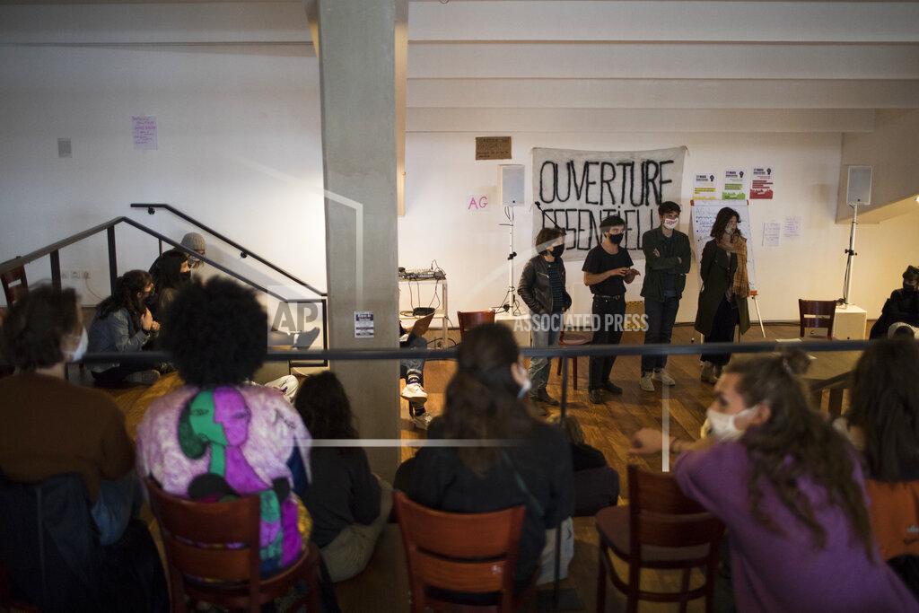 Daniel Cole CORRECTING DATE TO 26 - Culture workers, actors, students, and theater employees attend a general assembly at the occupied Theatre de La Criee in Marseille, southern France, Friday, March 26, 2021. Out-of-work French culture and tourism workers are occupying theaters accross France to demand more government support after a year of pandemic that has devastated their incomes and put their livelihoods on indefinite hold. (AP Photo/Daniel Cole)