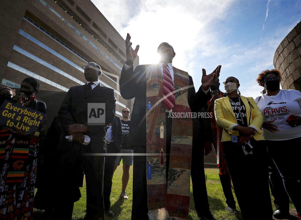 Patrick Lantrip Pastor and University of Memphis professor Andre E. Johnson leads a prayer vigil for Pervis Payne outside of the Shelby County Criminal Justice Center on Friday, June 4, 2021 in Memphis. A hearing is scheduled Friday in the case of Payne, a Tennessee death row inmate who has long maintained his innocence and whose lawyers filed a petition saying he is intellectually disabled and should not be executed. (Patrick Lantrip/Daily Memphian via AP)