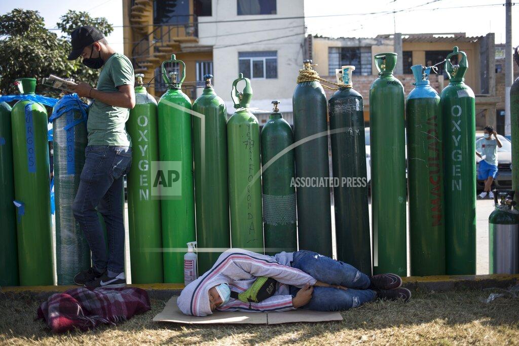 Rodrigo Abd People wait in a line with empty oxygen tanks hoping to refill the canisters for relatives suffering from COVID-19, in Lima, Peru, Friday, Jan. 29, 2021. The Andean country was one of the worst-hit in the region by the new coronavirus pandemic during 2020 and is now experiencing a resurgence in cases. (AP Photo/Rodrigo Abd)
