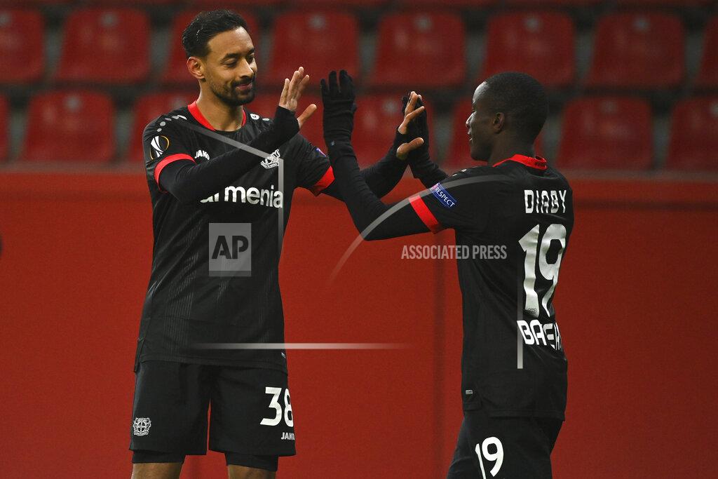 Ina Fassbender Leverkusen's Karim Bellarabi, left, celebrates with team mate Leverkusen's Moussa Diaby after scoring his side's fourth goal during the Europa League Group C soccer match between Bayer Leverkusen 04 and Slavia Prague at the BayArena in Leverkusen, Germany, Thursday, Dec. 10, 2020. (AP Photo/Ina Fassbender, Pool)