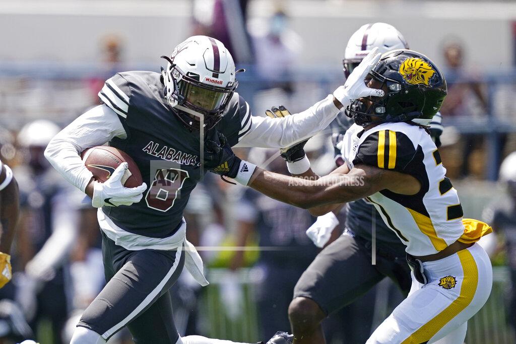 Rogelio V. Solis Alabama A&M wide receiver Zabrian Moore (8) attempts to fight off a tackle by an Arkansas-Pine Bluff defender after a pass reception during the first half of the Southwestern Athletic Conference NCAA college football game, Saturday, May 1, 2021, in Jackson, Miss. (AP Photo/Rogelio V. Solis)