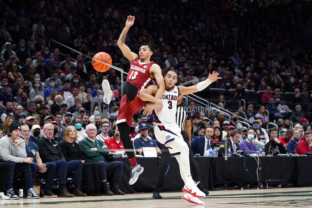 Elaine Thompson Alabama's Jahvon Quinerly, left, and Gonzaga's Andrew Nembhard (3) collide while chasing the ball during the first half of an NCAA college basketball game Saturday, Dec. 4, 2021, in Seattle. (AP Photo/Elaine Thompson)
