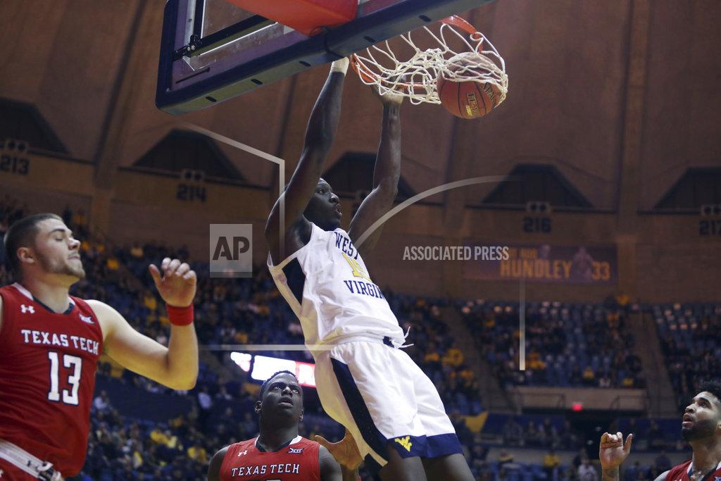 Ray Thompson West Virginia forward Lamont West (15) dunks while defended by Texas Tech guard Matt Mooney (13) during the second half of an NCAA college basketball game Wednesday, Jan. 2, 2019, in Morgantown, W.Va. Texas Tech defeated West Virginia 62-59. (AP Photo/Raymond Thompson)
