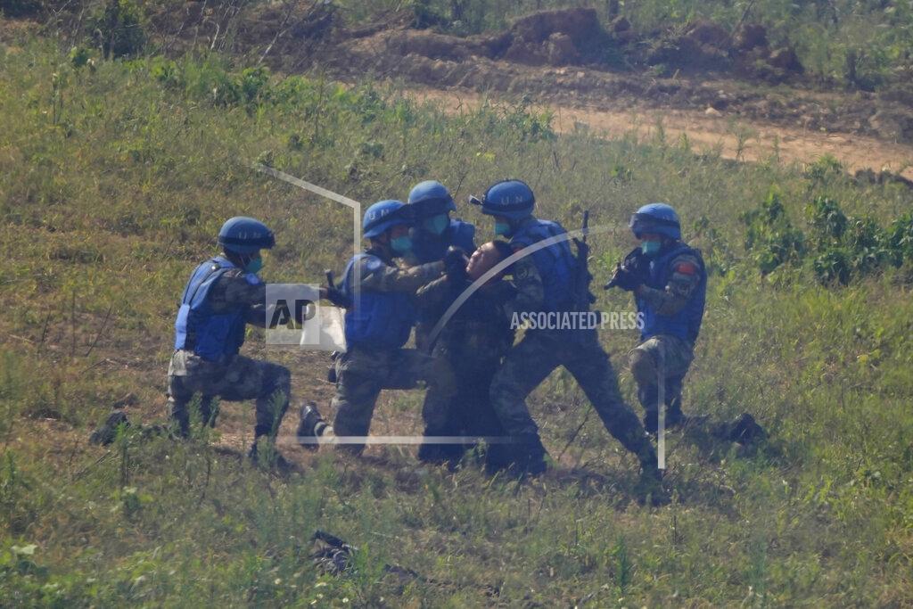 Ng Han Guan United Nations troops extract samples of a mock terrorist who surrendered after a failed attack on a United Nations base during the Shared Destiny 2021 drill at the Queshan Peacekeeping Operation training base in Queshan County in central China's Henan province Wednesday, Sept. 15, 2021. Peacekeeping troops from China, Thailand, Mongolia and Pakistan took part in the 10 days long exercise that field reconnaissance, armed escort, response to terrorist attacks, medical evacuation and epidemic control. (AP Photo/Ng Han Guan)