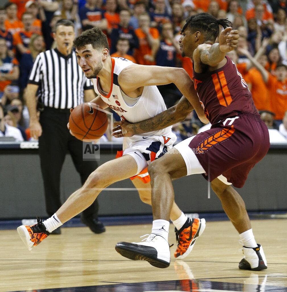 Steve Helber Virginia guard Ty Jerome (11) drives past Virginia Tech guard Ahmed Hill, right, during the first half of an NCAA college basketball game in Charlottesville, Va., Tuesday, Jan. 15, 2019. (AP Photo/Steve Helber)