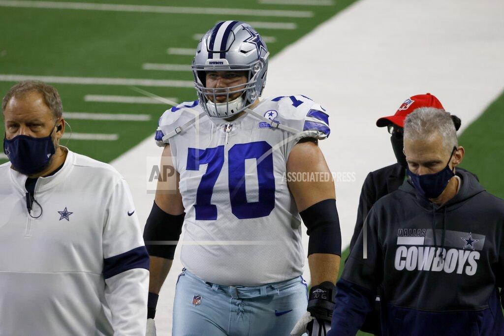Ron Jenkins Dallas Cowboys guard Zack Martin (70) is escorted off the field after suffering an unknown injury in the first half of an NFL football game against the Arizona Cardinals in Arlington, Texas, Monday, Oct. 19, 2020. (AP Photo/Ron Jenkins)