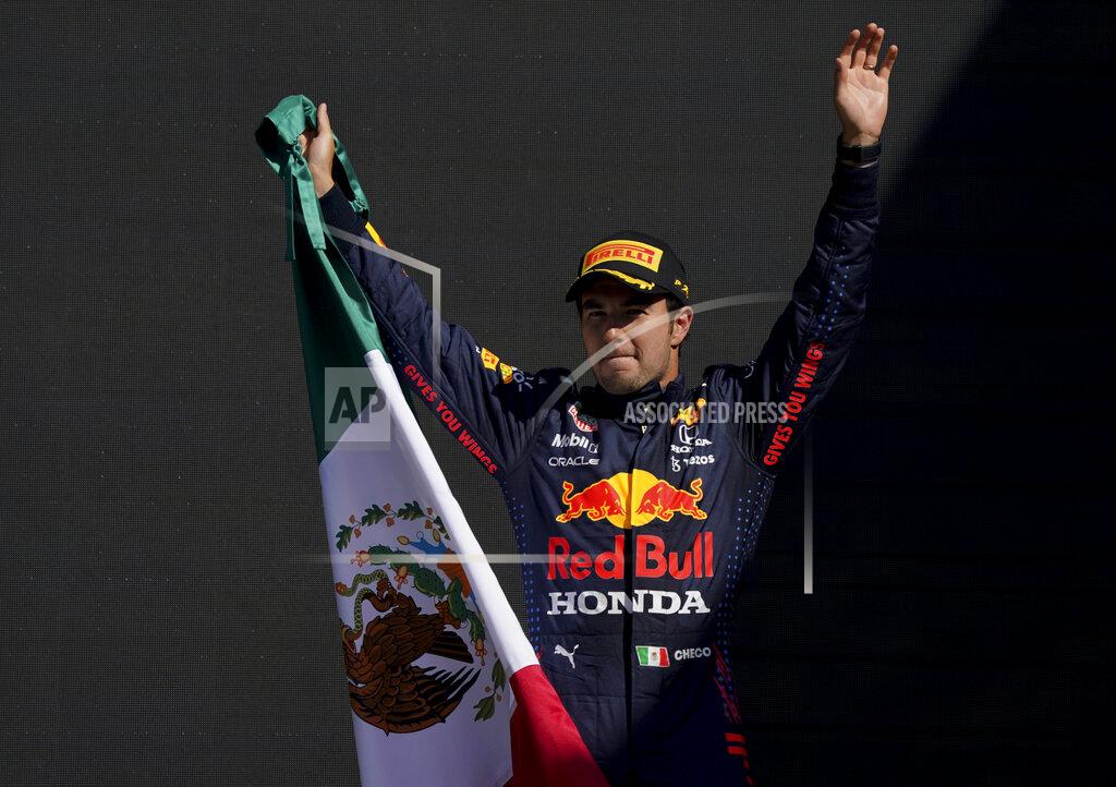 Fernando Llano Red Bull's Sergio Perez holds a Mexican flag as he celebrates winning third place of the Formula One Mexico Grand Prix auto race at the Hermanos Rodriguez racetrack in Mexico City, Sunday, Nov. 7, 2021. (AP Photo/Fernando Llano)