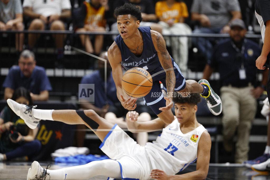 Jeff Swinger Memphis Grizzlies guard Ronaldo Segu, top, gets off a pass against Oklahoma City Thunder forward Ousmane Dieng (13) during the first half an NBA summer league basketball game Wednesday, July 6, 2022, in Salt Lake City. (AP Photo/Jeff Swinger)