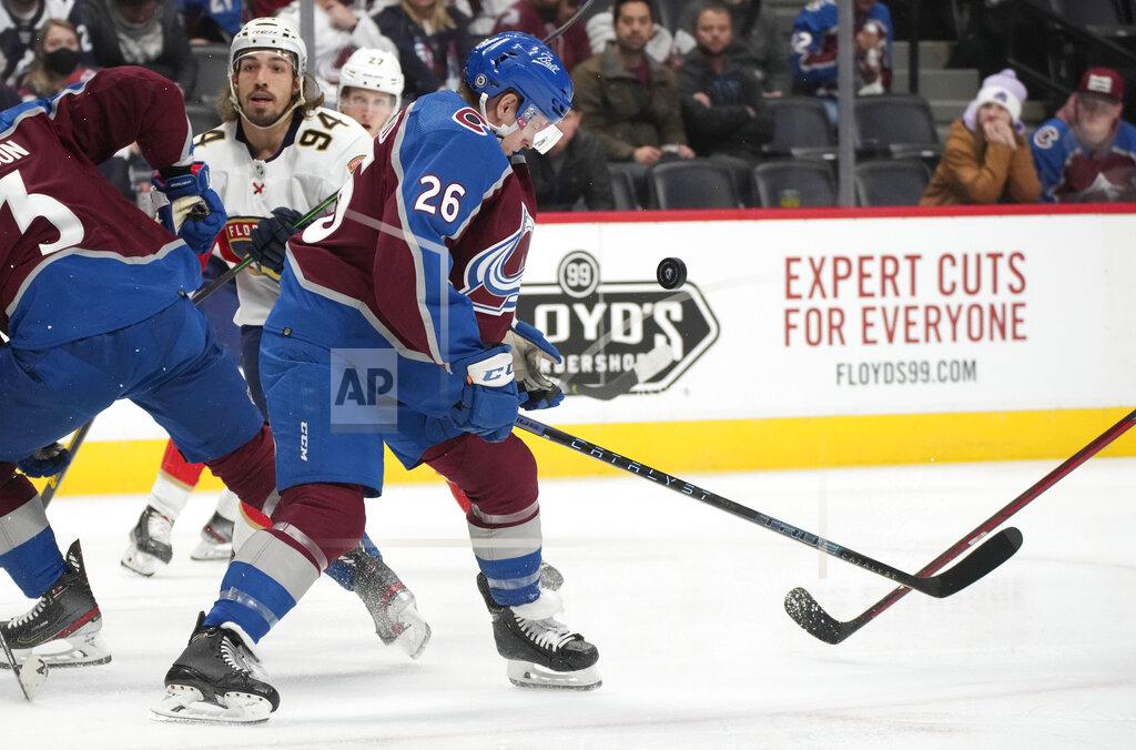David Zalubowski Colorado Avalanche defenseman Jacob MacDonald gets hit with the puck while stopping a shot against the Florida Panthers in the second period of an NHL hockey game Sunday, Dec. 12, 2021, in Denver. (AP Photo/David Zalubowski)