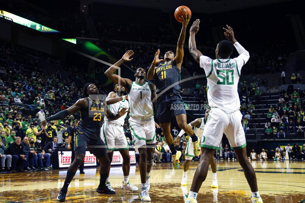 Thomas Boyd Baylor guard James Akinjo (11) shoots against Oregon during the first half of an NCAA college basketball game in Eugene, Ore., Saturday, Dec. 18, 2021. (AP Photo/Thomas Boyd)
