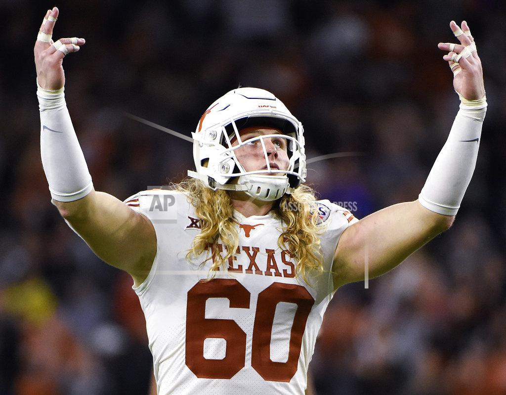 FILE - In this Dec. 27, 2017 file photo, Texas linebacker Breckyn Hager gestures to the crowd before a third-down play during the second half of the Texas Bowl NCAA college football game against Missouri in Houston. The frustration at Texas is visible in Hager's flowing golden curls. Hager was a freshman when he vowed he wouldn’t cut his hair until Texas won the Big 12. (AP Photo/Eric Christian Smith, file)