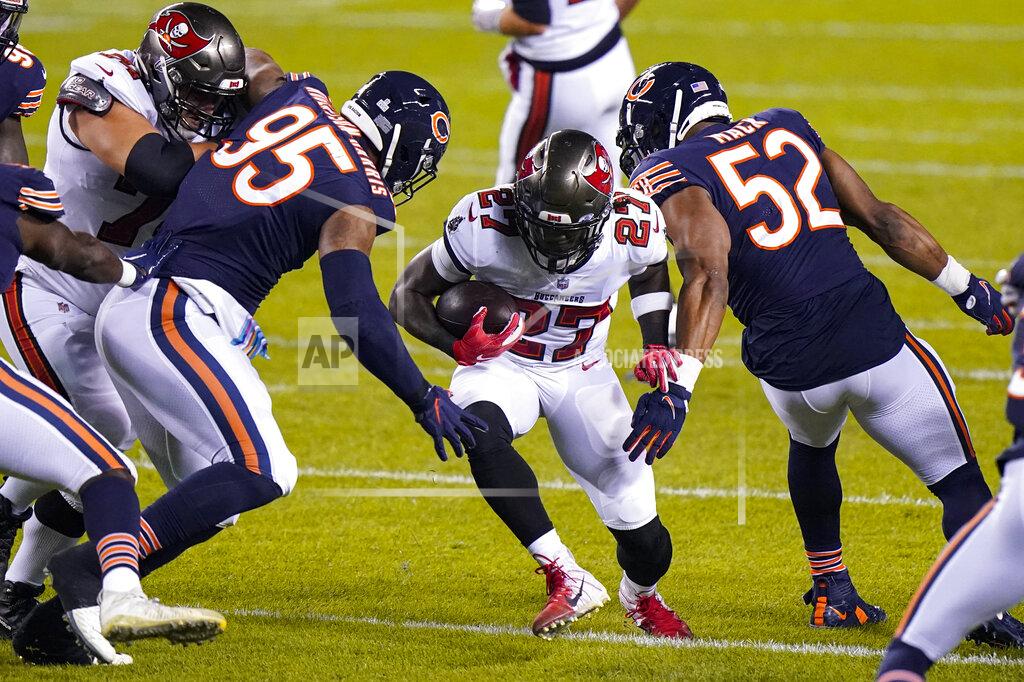 Nam Y. Huh Tampa Bay Buccaneers running back Ronald Jones (27) cuts between Chicago Bears defensive end Roy Robertson-Harris (95) and outside linebacker Khalil Mack (52) during the first half of an NFL football game in Chicago, Thursday, Oct. 8, 2020. (AP Photo/Nam Y. Huh)