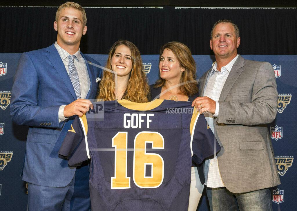 CORRECTS TO NANCY GOFF-File-This April 29, 2016, file photo shows California's Jared Goff posing for photos with his family after being selected by the Los Angeles Rams as the first pick in the first round of the NFL football draft, in Los Angeles. From left, Jared Goff with sister, Lauren Goff and parents, Nancy Goff and Jerry Goff. The Montreal Expos would be thrilled with this Super Bowl, and those who used to be part of the extinct baseball franchise’s evaluation process certainly are, even all these years later. Gone from the game for nearly 15 years, the former club has ties to both quarterbacks in Sunday’s NFL championship game. The Expos traded for Jared Goff’s father, Jerry, nearly three decades ago. Goff made his major league debut for Montreal in 1990 and played 55 games for the team as a backup catcher that year and in 1992.(AP Photo/Damian Dovarganes, File)