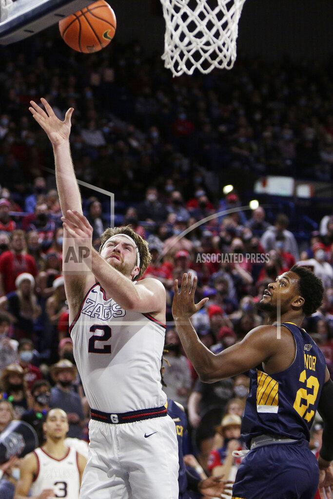 Young Kwak Gonzaga forward Drew Timme (2) shoots next to Merrimack forward Jordan Minor (22) during the first half of an NCAA college basketball game Thursday, Dec. 9, 2021, in Spokane, Wash. (AP Photo/Young Kwak)