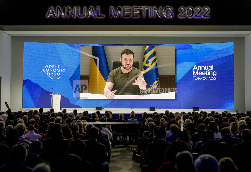 Markus Schreiber Ukrainian President Volodymyr Zelenskyy displayed on a screen as he addresses the audience from Kyiv on a screen during the World Economic Forum in Davos, Switzerland, Monday, May 23, 2022. The annual meeting of the World Economic Forum is taking place in Davos from May 22 until May 26, 2022. (AP Photo/Markus Schreiber)