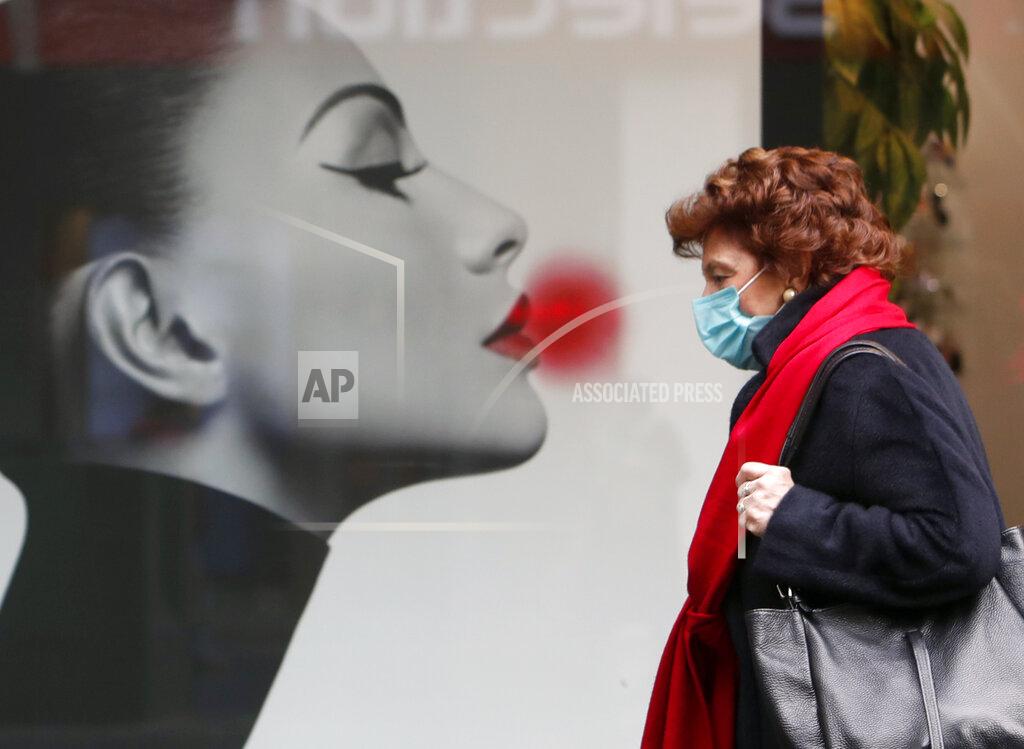 Darko Vojinovic A woman wearing a face mask to protect against coronavirus walks along Belgrade's main pedestrian street, in Serbia, Thursday, Dec. 31, 2020. (AP Photo/Darko Vojinovic)